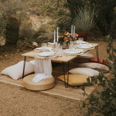 The best summer candles laid out on an outdoor table setting