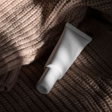 Close up of unbranded moisturiser on a knitted jumper