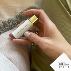 katie holding a bottle of the westman atelier vital skincare concealer