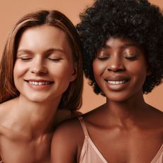 Best eye creams - close up of white woman and a black woman with their eyes closed