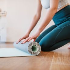 A woman doing low impact Pilates workouts at home